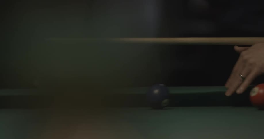 Person is playing on a pool table