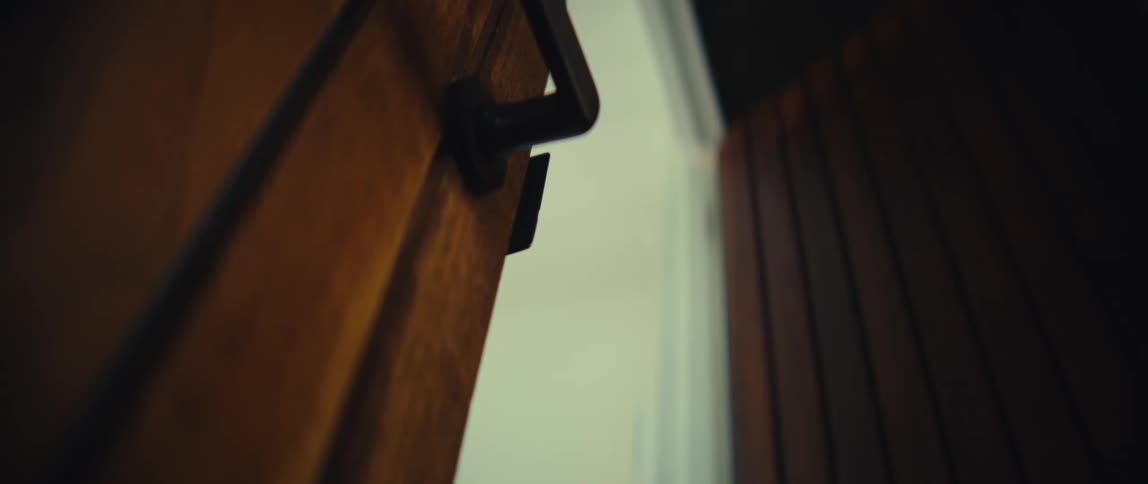 The man enters the home with a cell phone and locks the door