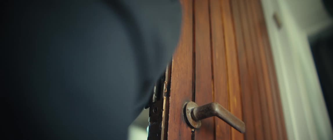 Person opening the door of the residence with a key