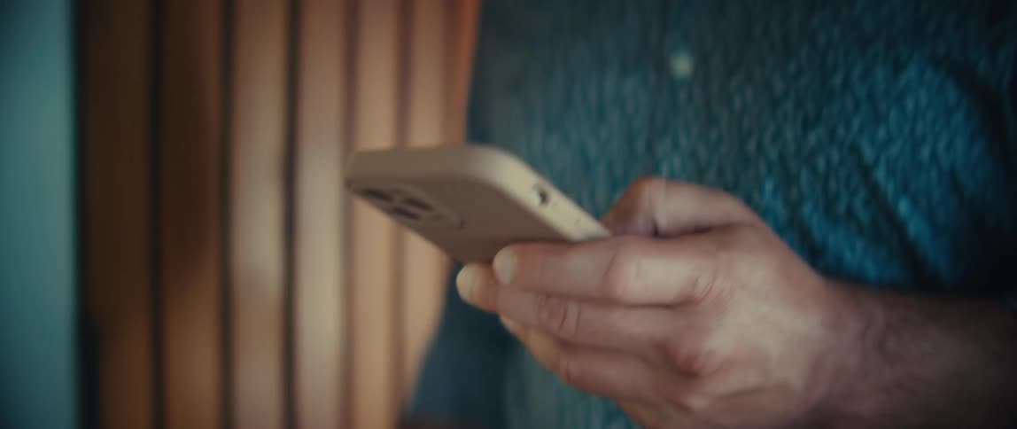 The man enters his home while using a phone