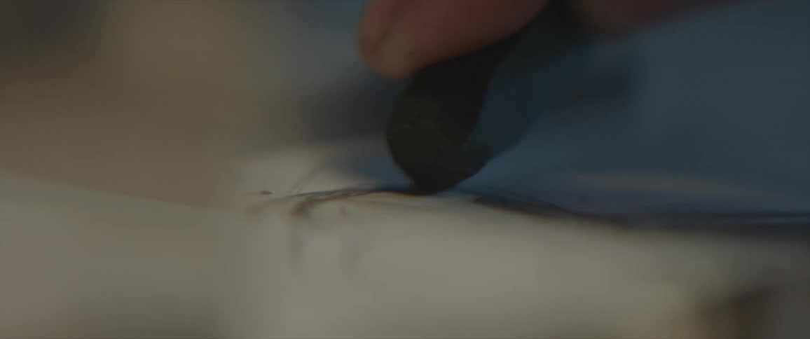 An artist sketches in a notepad