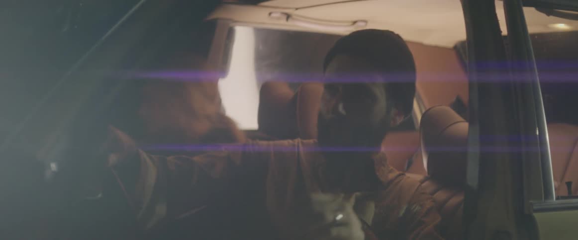 Man and woman get out of parked car at night