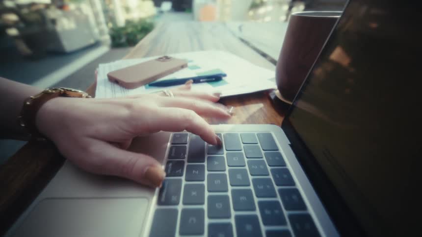 The woman is typing on her laptop at home