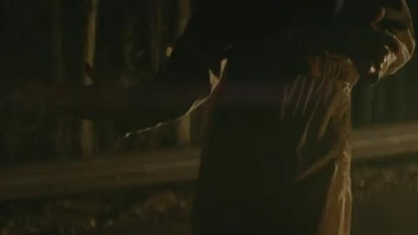 Person dancing in the dark with a flashing light