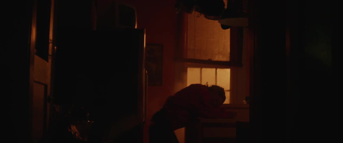 Woman leans on a kitchen counter with a light flashing on and off