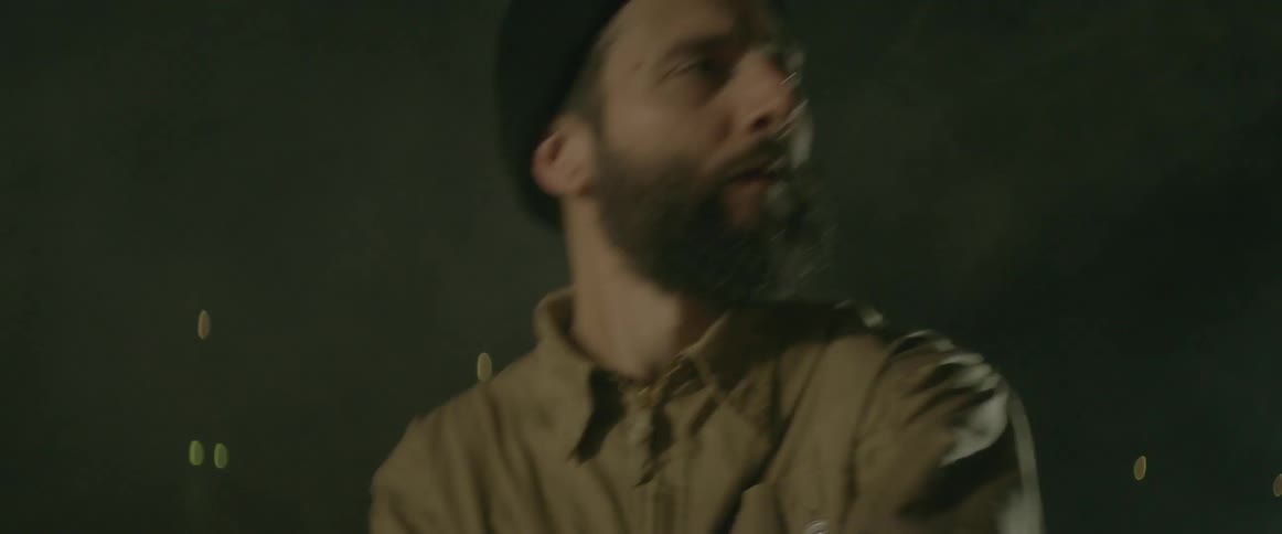 A man dances at night with lights flashing