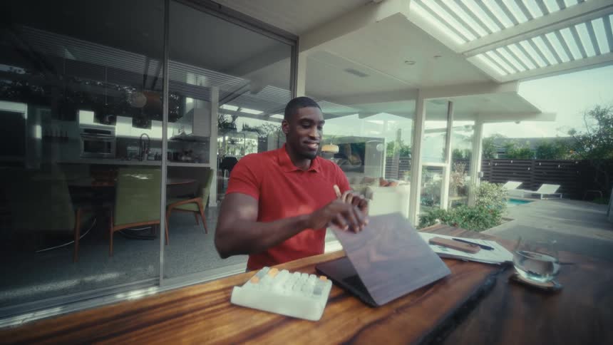 Man closing his laptop with a smile