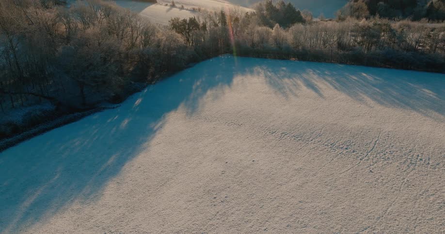 An aerial view of a landscape covered in snow