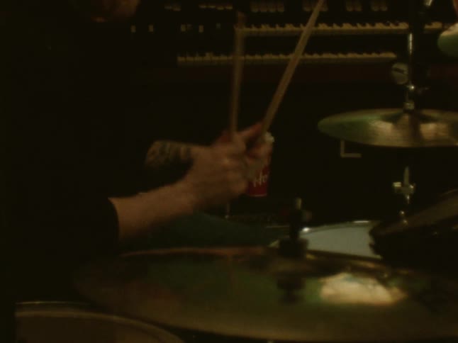 A man playing drums in a room