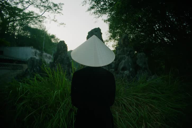 A person wearing a hat out in a wooded area