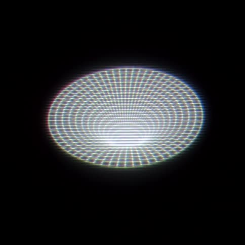 A glowing elliptical form composed of concentric rings pulses with a digital scanline effect against a dark void in the center the faint text insur is visible through the shimmering moirpatterned light