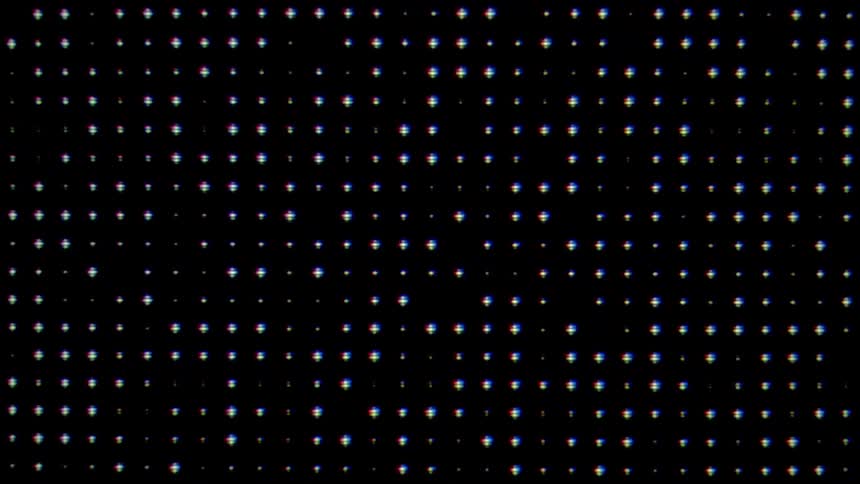 A screen with a black background has an array of many blinking dots