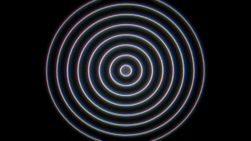 A spiral animation spinning and growing larger on a dark screen