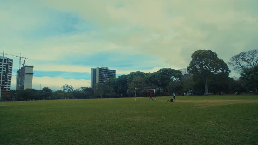 Two people playing soccer outdoors
