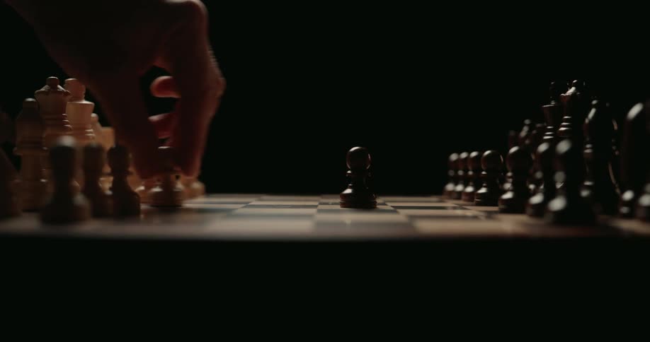 Two people playing chess in a room
