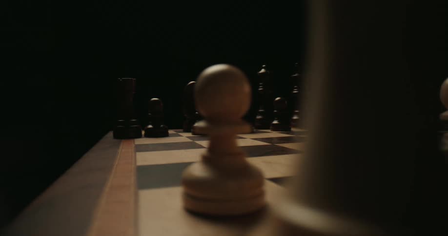 A view moves across a chessboard revealing the dark pieces and then the light pieces
