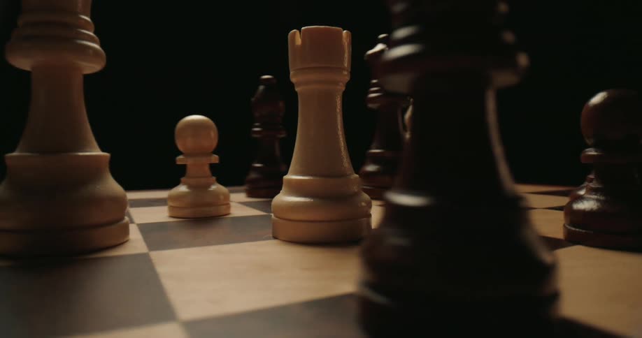 Several chess pieces are placed atop a checkered chess board