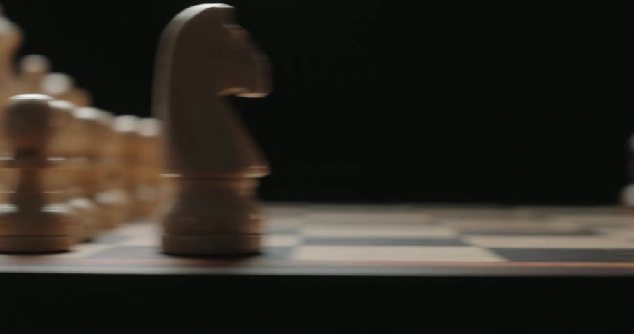 Two people playing chess at a board