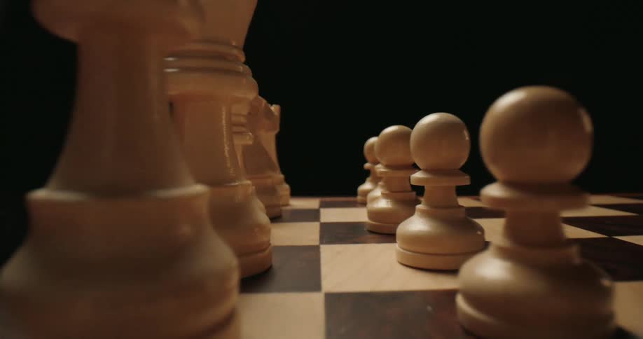 Closeup of white pieces on a chessboard