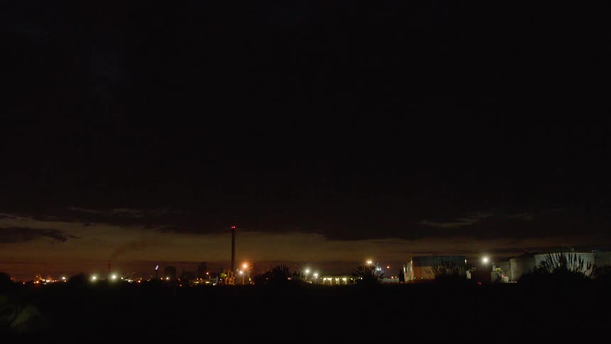 A city skyline at night with streetlights illuminating the surroundings