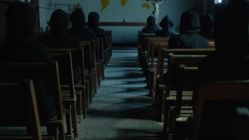 A group of people sitting in pews in a church