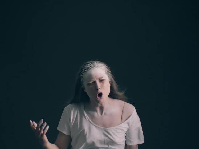 The woman is screaming with powder on her face