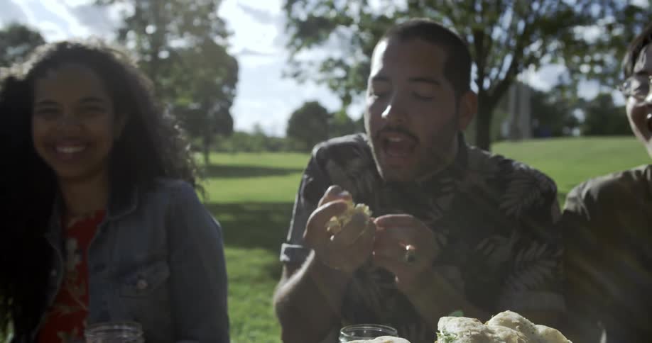 A woman grabs a handful of popcorn