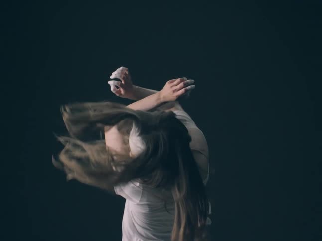 The crossing diagonal lines created by her forearms as she raises them toward her facethe vertical line of her hair as it whips and falls downward while she turns her head