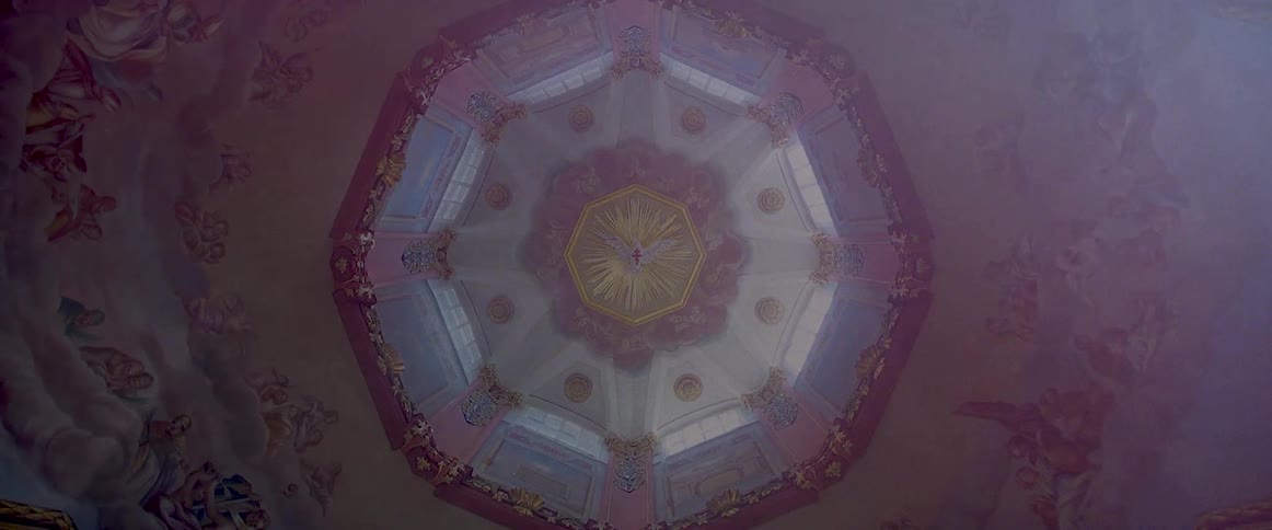 The interior of a building or a church with a painted ceiling