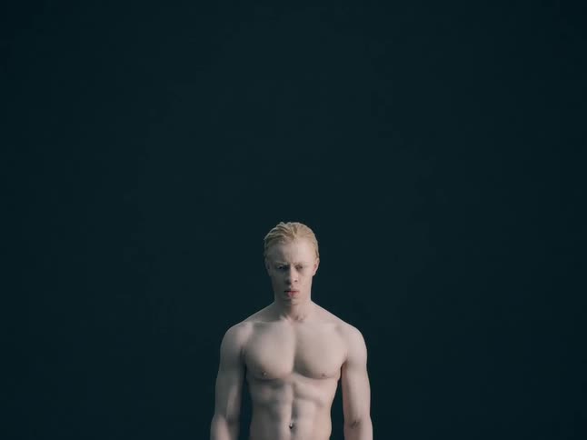 A muscular man with no shirt abruptly yells out in anger
