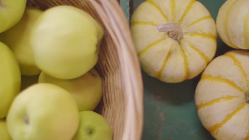 Apples and squash in baskets next to each other