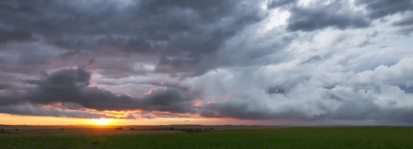 Heavy clouds and sunset over a natural landscape outdoors