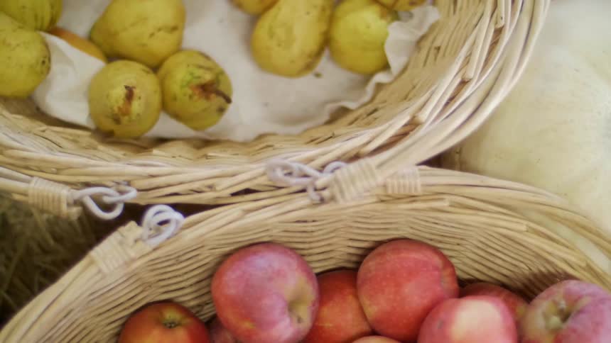 Apples and pears in wicker baskets