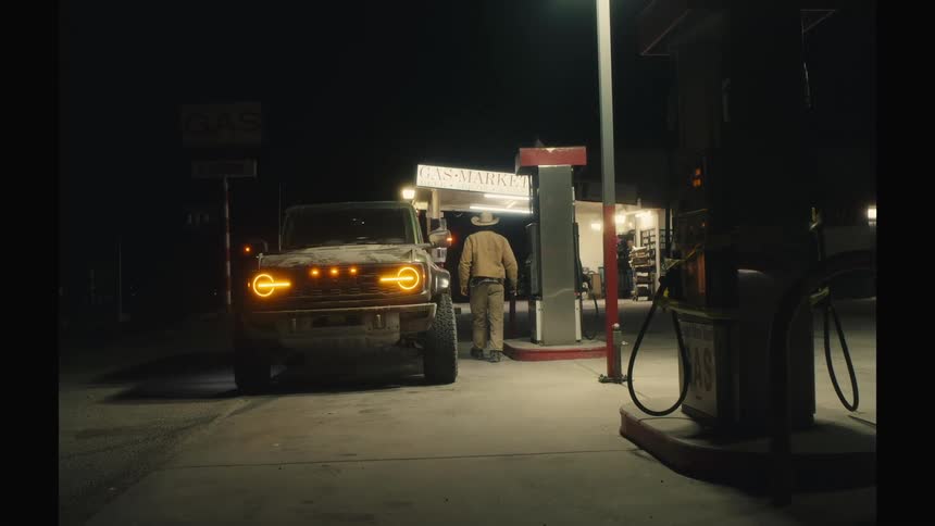A man gets out of his vehicle at a gas station