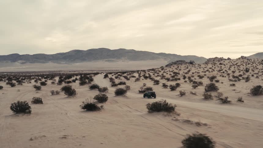 A vehicle driving outdoors in the desert
