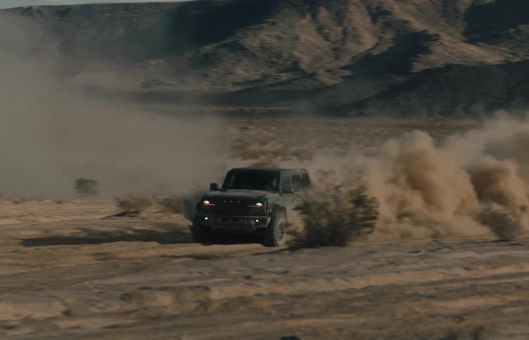 A vehicle driving offroad in the desert