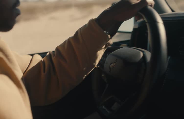 A man driving a vehicle in the desert