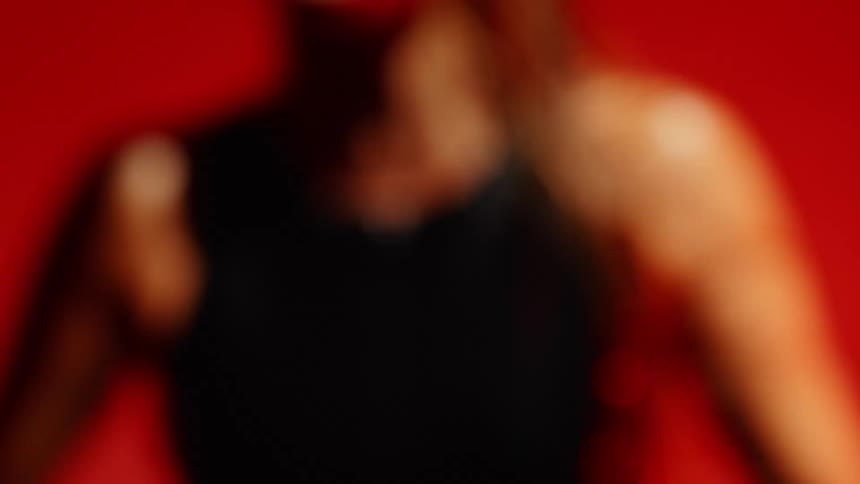 A model wearing a black shirt turns to the side
