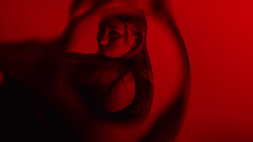 Woman with wet hair performs a spinning movement with a circular blur effect