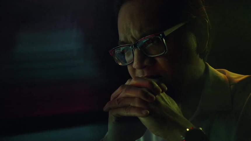 A man sitting in a room looking in the distance