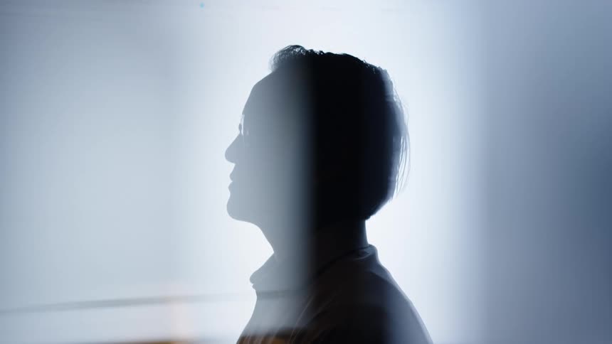A portrait of a mans face in a room