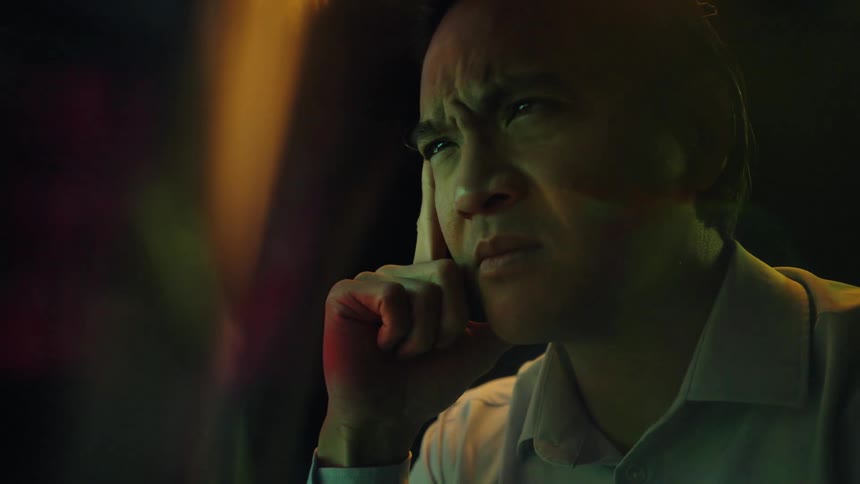 A man in glasses looks intensely at a screen displaying financial data appearing deep in thoughthe eventually removes his glasses and rubs his face looking stressed or exhausted by what he sees