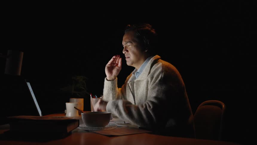 A man looking at a computer screen in a room