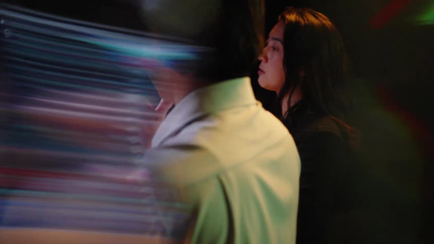 A man and woman looking at computer screens