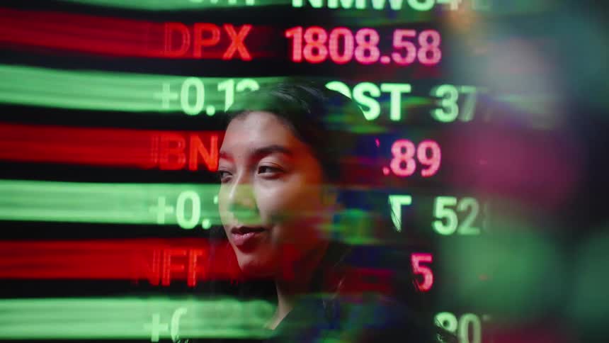 An asian woman gazes forward before turning her head as vibrant green and red stock market ticker numbers streak across the frame creating a fastpaced and immersive digital financial atmosphere