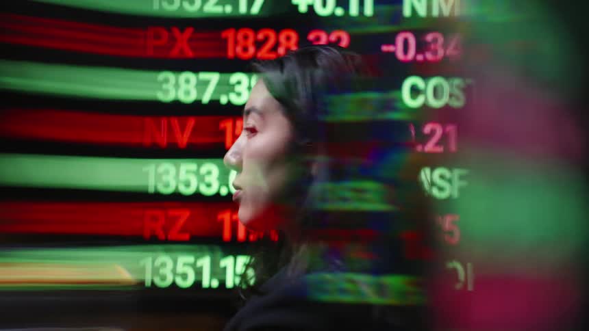 The woman turns from the stock ticker
