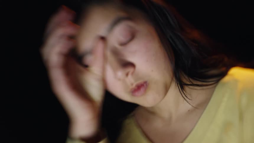 A woman looking at a screen in a room