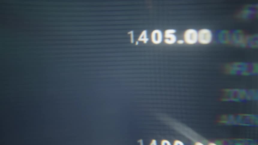 Graphs and stock prices are on the computer screen