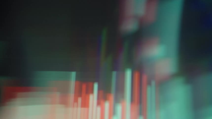 Glowing charts and financial data move across the screen in a blur of colors