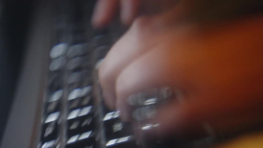 A person typing on a laptop
